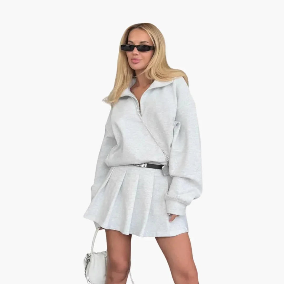 Pull femme avec demi-zip et jupe plissée